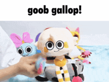 a person is holding a stuffed animal that says goob gallop on it