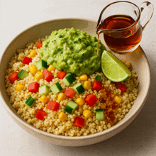 a bowl of couscous with guacamole and syrup on top