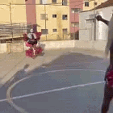 a person is jumping in the air on a basketball court while holding a basketball .