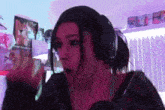 a woman wearing headphones is making a funny face