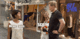 a man and woman are standing in front of a store that says alice 's court