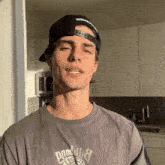 a man wearing a hat and a t-shirt that says " goodwill "