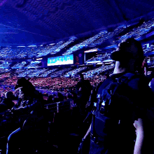 a crowd of people watching a concert with a sign that says shield