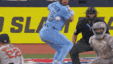 a baseball player wearing a blue jersey with the number 5 on it