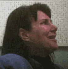 a woman is sitting in front of a wall with numbers on it .