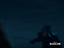 a blurred image of a man in a superhero costume with the words " keluarg man " at the bottom