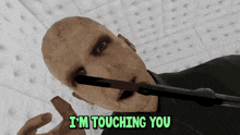 a bald man with a wand in his mouth and the words i 'm touching you