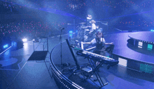 a woman is playing a roland keyboard on stage