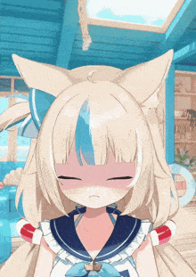 a girl with a cat ear and a sailor outfit is making a face