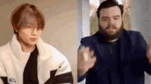 a man with a beard is standing next to another man with a white jacket .