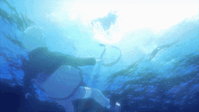 a person is swimming in the ocean with the sun shining through