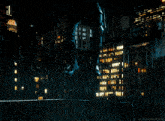 a man in a daredevil costume kneeling in the rain