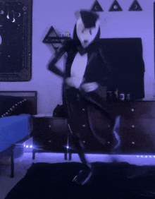a person in a panda costume is dancing in a dark room