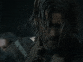 a man with a beard is covered in mud