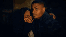 a man and a woman are standing next to each other and looking scared