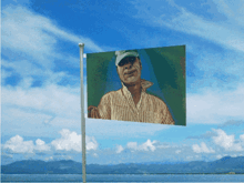 a flag with a picture of a man in a baseball cap