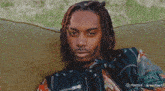 a man with dreadlocks is sitting on a couch with a minimax logo on the bottom