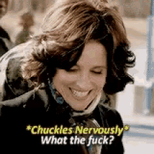 a woman is smiling and saying `` chuckles nervously what the fuck ''