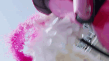a close up of a pink and white furry object