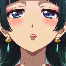 a close up of a girl 's face with blue eyes and earrings