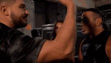 a man flexing his arm with the words " this is working " behind him