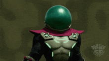 a superhero with a green helmet and a red cape points his finger