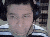 a man wearing headphones with a microphone on his head .