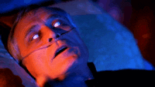 a man is laying in bed with an oxygen mask on his nose