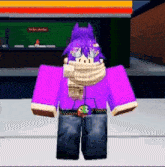 a person wearing a purple shirt and scarf is standing in front of a fast food restaurant .