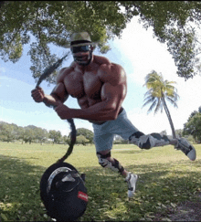 a man with huge muscles is holding a rope in a park