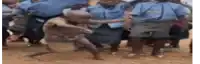a group of police officers are standing around a group of children .