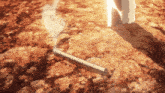 a cigarette is laying on the ground with a smoke trail