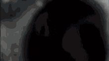 a close up of a person 's face in the dark with a blurred background .