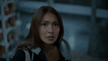 a close up of a woman 's face looking at the camera