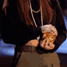 Holding A Gold Skull Angel Rose GIF - Holding A Gold Skull Angel Rose Ink Master GIFs