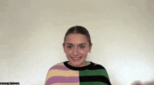 a woman wearing a striped sweater is smiling with the name jenna burness in the corner
