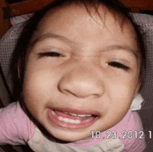 a close up of a child 's face with the date 10.23 2012 on the bottom