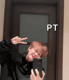 a person taking a picture of themselves in a mirror with the word pt above it