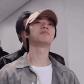 a man wearing a hat with the letter e on it looks up