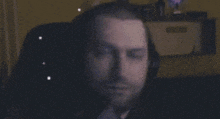a blurry picture of a man wearing headphones and a microphone .