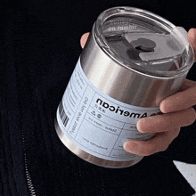 a person is holding a stainless steel container with a label that says " collage on tumblr " on it