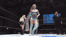 a woman in a wrestling ring stands in front of a sign that says ' samurai ' on it