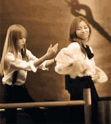a couple of girls are standing next to each other dancing