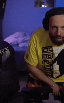 a man wearing headphones and a yellow shirt that says 1988 on it