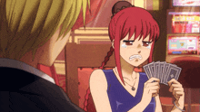 a woman with red hair is holding a bunch of cards