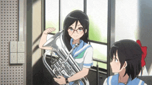 a girl in a blue and white uniform is holding a silver trumpet