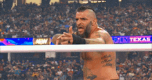 a man in a wrestling ring has a tattoo on his chest that says mary 's maid mary
