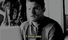 a man is sitting in front of a laptop and says i miss you