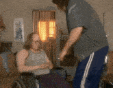 a man in a wheelchair is being helped by another man