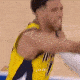 a basketball player in a yellow jersey with jordy written on the back